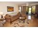 Spacious living room with a view of the patio and a cozy seating arrangement at 175 Kings Hwy # 411, Punta Gorda, FL 33983