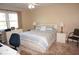 Bedroom with a queen-size bed, desk and chair, and neutral decor at 175 Kings Hwy # 411, Punta Gorda, FL 33983