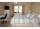 Bright bedroom with a large bed, dresser, and workspace at 175 Kings Hwy # 411, Punta Gorda, FL 33983