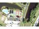 Aerial view showing community pool, tennis courts, and parking at 175 Kings Hwy # 411, Punta Gorda, FL 33983