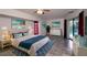 Main bedroom with tile flooring, large bed and pool access at 21445 Peachland Blvd, Port Charlotte, FL 33954