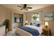 Bedroom with tile flooring, ceiling fan and closet with clothes at 21445 Peachland Blvd, Port Charlotte, FL 33954