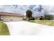 Two-car garage with a long driveway at 21445 Peachland Blvd, Port Charlotte, FL 33954