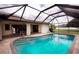 Inviting pool area with a screened enclosure at 21445 Peachland Blvd, Port Charlotte, FL 33954