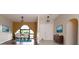 Dining room features tile flooring and an arched window, seating for four at 21445 Peachland Blvd, Port Charlotte, FL 33954
