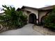 Front entrance with walkway, landscaping, and red accents at 21445 Peachland Blvd, Port Charlotte, FL 33954