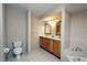 Bathroom with double vanity, tile flooring, and bathtub at 21445 Peachland Blvd, Port Charlotte, FL 33954