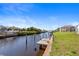 View of canal with private dock and neighboring houses at 18882 Ayrshire Cir, Port Charlotte, FL 33948