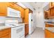 Modern kitchen with white appliances and wood cabinets at 18882 Ayrshire Cir, Port Charlotte, FL 33948