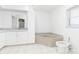 Bathroom with white vanity, corner tub, and toilet at 18882 Ayrshire Cir, Port Charlotte, FL 33948