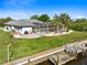 Aerial view of canal-front property with pool and private dock at 18882 Ayrshire Cir, Port Charlotte, FL 33948