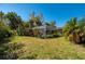 Landscaped backyard with a screened pool and lush greenery at 1150 Winston St, Port Charlotte, FL 33952