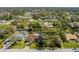 Expansive aerial view of home featuring large backyard, mature trees, and inviting swimming pool at 1150 Winston St, Port Charlotte, FL 33952