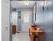 Inviting entryway with console table and glass block window at 1150 Winston St, Port Charlotte, FL 33952