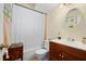 Main bathroom with shower/tub combo and wood vanity at 1150 Winston St, Port Charlotte, FL 33952