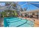 Spacious pool area with screened enclosure and patio furniture at 1150 Winston St, Port Charlotte, FL 33952