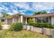 Charming single-story home with a gray garage door and lush landscaping at 1150 Winston St, Port Charlotte, FL 33952