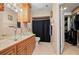 Bathroom with double vanity, glass sinks, and walk-in closet at 1150 Winston St, Port Charlotte, FL 33952