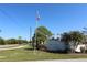 Fiddlers Green community entrance with signage and landscaping at 6800 Placida Rd # 144, Englewood, FL 34224