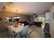 Dining area with white table and chairs, adjacent to living room at 6800 Placida Rd # 144, Englewood, FL 34224