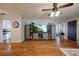 Spacious living room featuring hardwood floors, a large TV, and a rustic cabinet at 16115 Aralia Dr, Punta Gorda, FL 33955