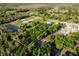 Aerial view showing a house on a large lot with surrounding trees and neighboring properties at 16115 Aralia Dr, Punta Gorda, FL 33955