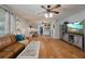 Open living room with hardwood floors, a leather couch, and a view into the dining area at 16115 Aralia Dr, Punta Gorda, FL 33955
