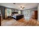 Large main bedroom with dark wood flooring and access to a backyard patio at 16115 Aralia Dr, Punta Gorda, FL 33955