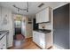 Kitchen with white cabinets, gray walls, and exterior access at 16115 Aralia Dr, Punta Gorda, FL 33955
