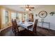 Bright dining room with large windows and a farmhouse-style table at 16115 Aralia Dr, Punta Gorda, FL 33955