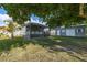 Gray house with a covered patio and detached shed in a lush green backyard at 16115 Aralia Dr, Punta Gorda, FL 33955
