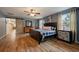 Spacious primary bedroom with wood-look floors and sliding barn door at 16115 Aralia Dr, Punta Gorda, FL 33955