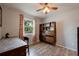 Bright bedroom with a built-in shelving unit and wood flooring at 16115 Aralia Dr, Punta Gorda, FL 33955