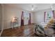 Bright bedroom with hardwood floors, window seating, and a built-in desk at 16115 Aralia Dr, Punta Gorda, FL 33955