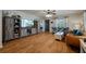Living room with hardwood floors, a large TV, and a rustic cabinet at 16115 Aralia Dr, Punta Gorda, FL 33955