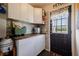 Laundry area with white cabinets and wood countertop at 16115 Aralia Dr, Punta Gorda, FL 33955