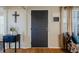 Home entry with dark gray door, hardwood floors, and charming decor at 16115 Aralia Dr, Punta Gorda, FL 33955