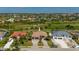 Two-story house with three-car garage, paver driveway, and landscaping at 669 Monaco Dr, Punta Gorda, FL 33950