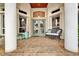 Front porch with double doors, wicker furniture, and tile flooring at 1700 Los Alamos Dr, Punta Gorda, FL 33950