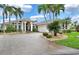 Two-story home with tile roof, palm trees, and circular driveway at 1700 Los Alamos Dr, Punta Gorda, FL 33950
