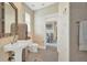 Bathroom with pedestal sink, toilet, and view into bedroom at 1700 Los Alamos Dr, Punta Gorda, FL 33950