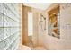 Walk-in shower with glass block wall and etched glass door at 1700 Los Alamos Dr, Punta Gorda, FL 33950
