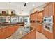 Island kitchen with granite countertops and wood cabinets at 1700 Los Alamos Dr, Punta Gorda, FL 33950