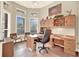 Bright home office with built-in cabinetry and hardwood floors at 1700 Los Alamos Dr, Punta Gorda, FL 33950
