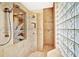Large walk-in shower with glass block wall and etched glass door at 1700 Los Alamos Dr, Punta Gorda, FL 33950