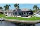 Beautiful waterfront home with a large pool and spa, screened patio, and lush landscaping at 1700 Los Alamos Dr, Punta Gorda, FL 33950