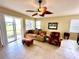 Living room features tiled floors, comfy seating and sliding glass doors at 24479 Vienison Ln, Punta Gorda, FL 33955