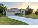 Well-maintained home with a large front yard and a two-car garage at 24479 Vienison Ln, Punta Gorda, FL 33955