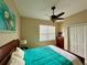 Bedroom with queen bed and ceiling fan at 24479 Vienison Ln, Punta Gorda, FL 33955