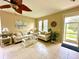 Living room with tiled floors, comfortable seating and neutral decor at 24479 Vienison Ln, Punta Gorda, FL 33955